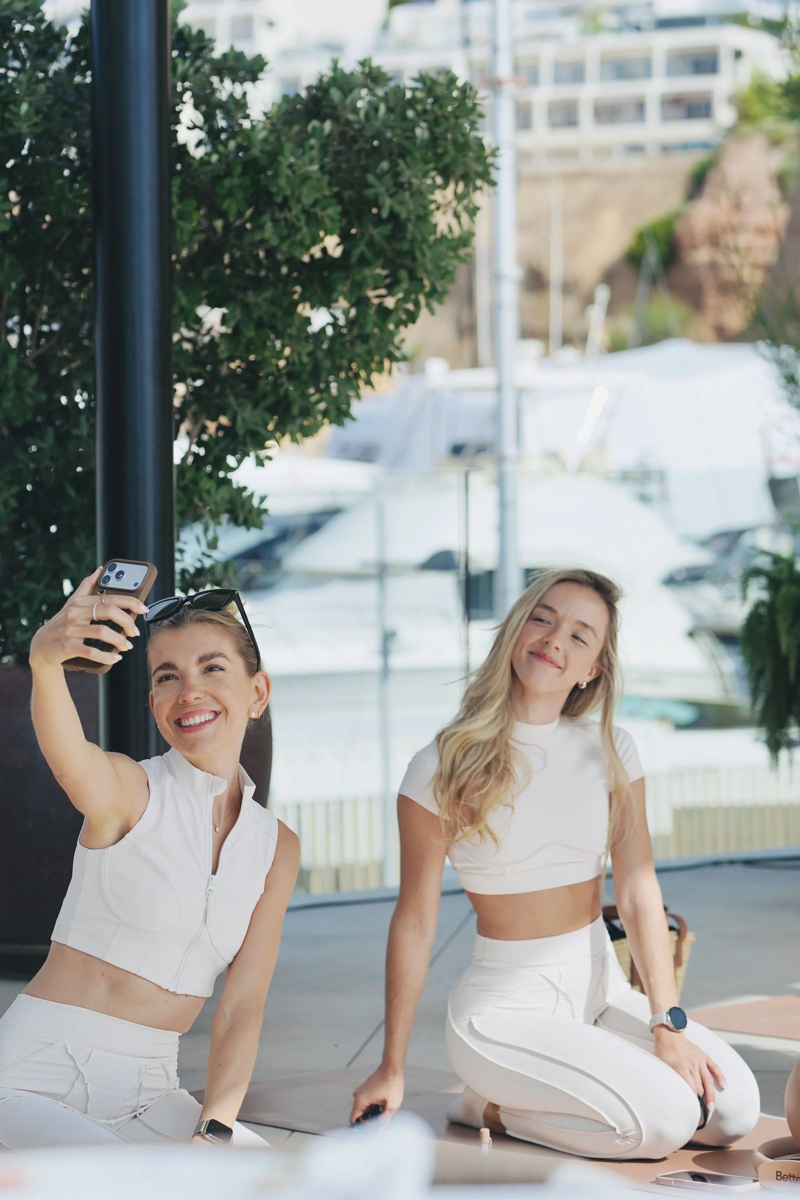 Friends sharing a moment at a beach club wellness event